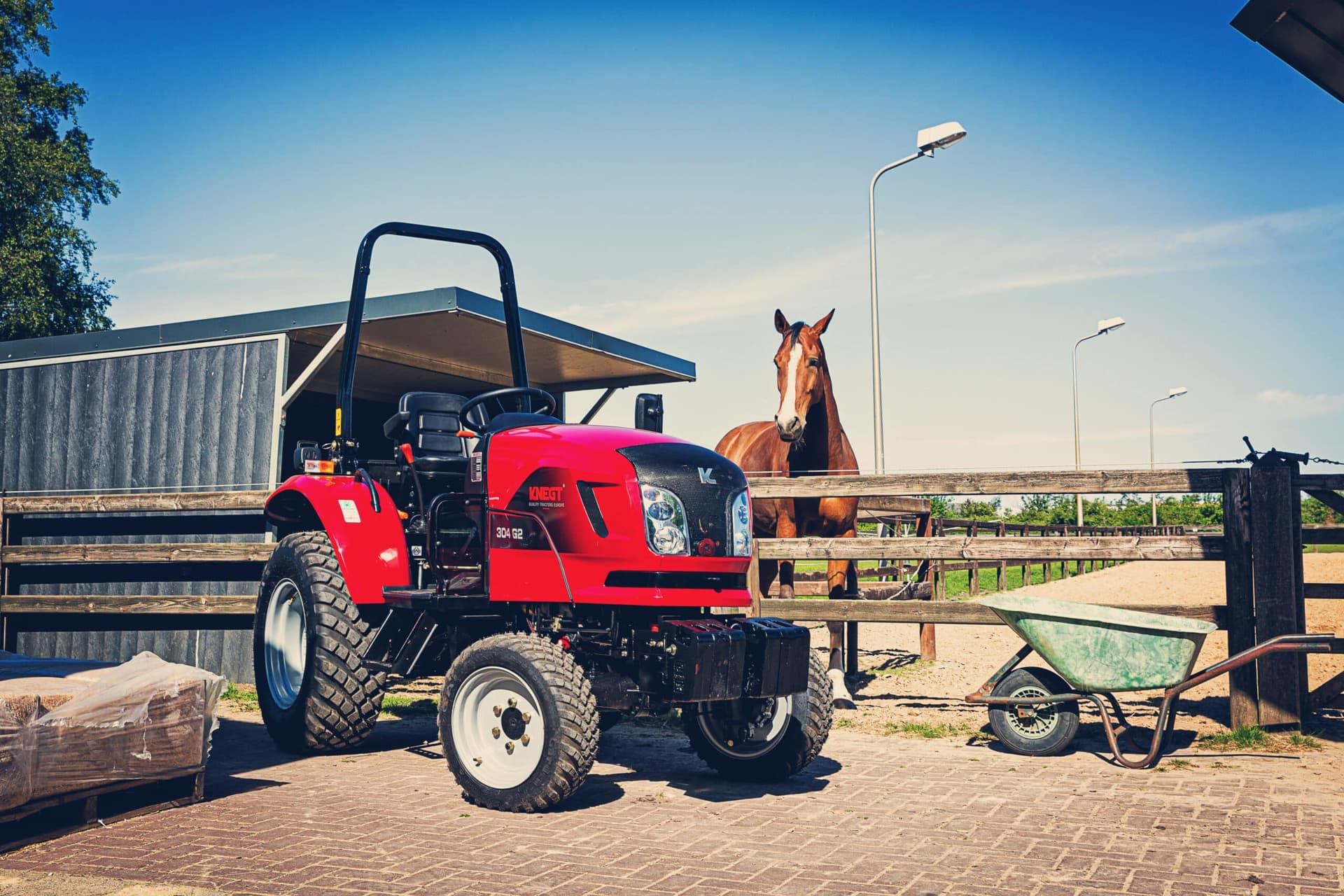 Diesel tractor at a stable with a horse